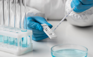 sensivity a Laboratorist wearing gloves while pipetting liquid sample in the kit | Allgloves